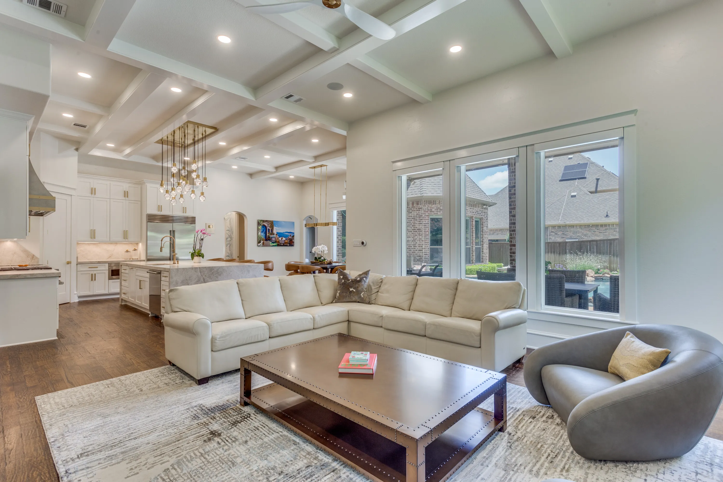 Family room sectional with kitchen island and dining table beyond