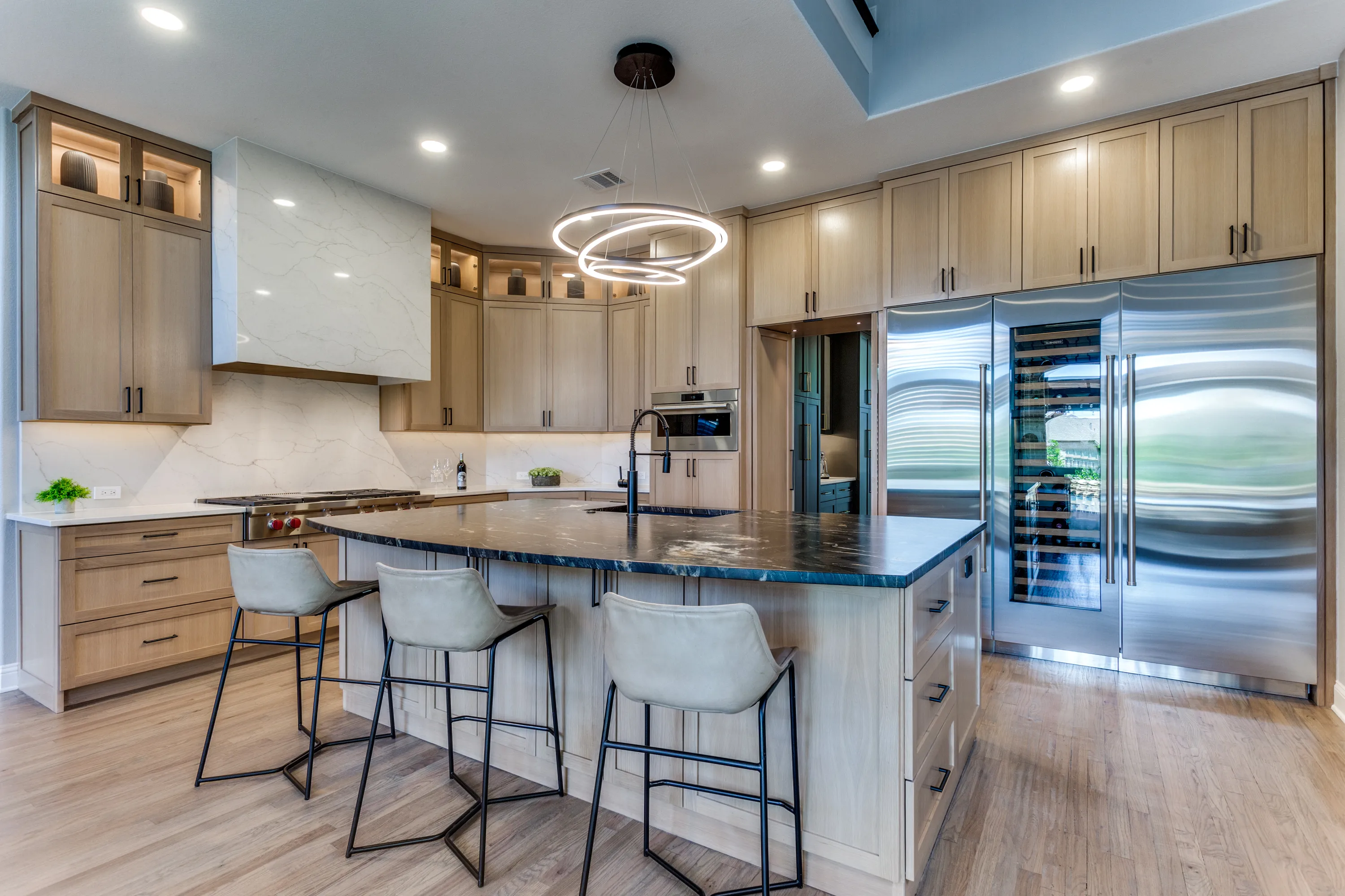 Kitchen wide view with the hidden butler's pantry entrance beyond