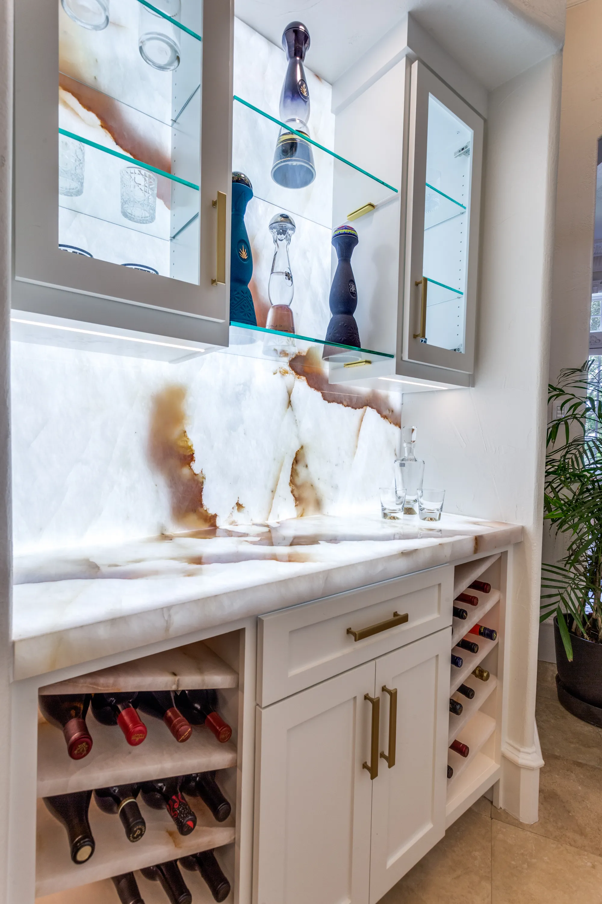 Illuminated Cristallo quartzite wine bar with glass display shelving and wine storage