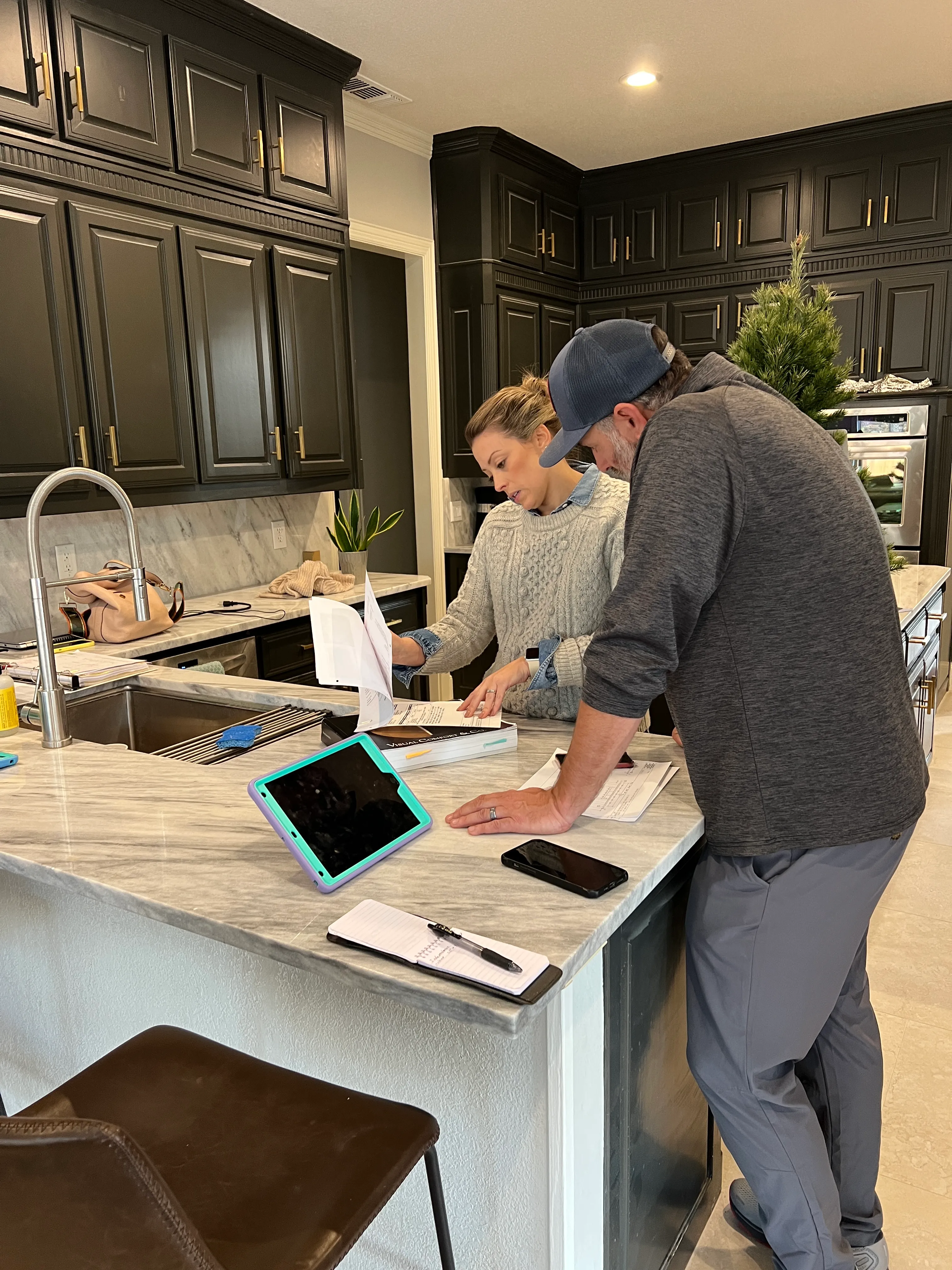 A completed kitchen and great room with drop cloths still in place before the final walkthrough.